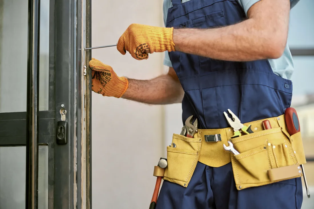 Tradesperson repairing a door
